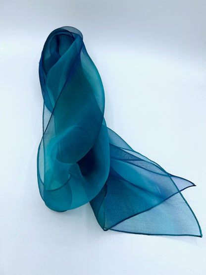 Experience the perfect harmony of art and elegance with our one-of-a-kind silk scarf—a designer accessory that transcends fashion into a realm of beauty and inspiration. Handcrafted with meticulous care, each piece is hand-dyed to create a stunning interplay of multicolor tones, forming a vibrant rainbow of hues that shimmer with soft transparency. Designed to complement any outfit, from casual wear to formal dresses, this versatile scarf enhances your personal style with a touch of uniqueness.