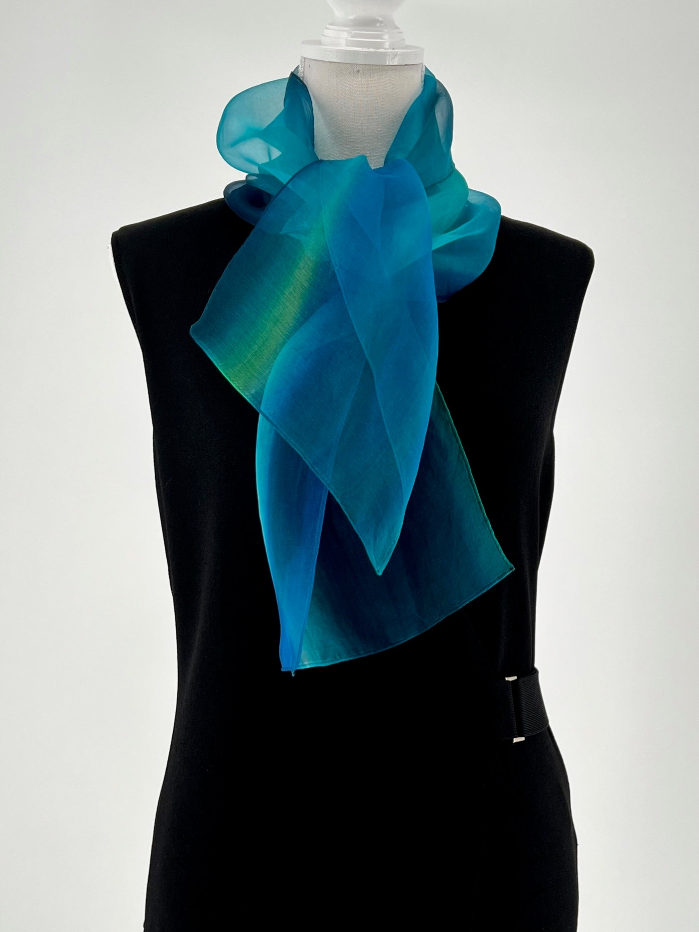 Experience the perfect harmony of art and elegance with our one-of-a-kind silk scarf—a designer accessory that transcends fashion into a realm of beauty and inspiration. Handcrafted with meticulous care, each piece is hand-dyed to create a stunning interplay of multicolor tones, forming a vibrant rainbow of hues that shimmer with soft transparency. Designed to complement any outfit, from casual wear to formal dresses, this versatile scarf enhances your personal style with a touch of uniqueness.