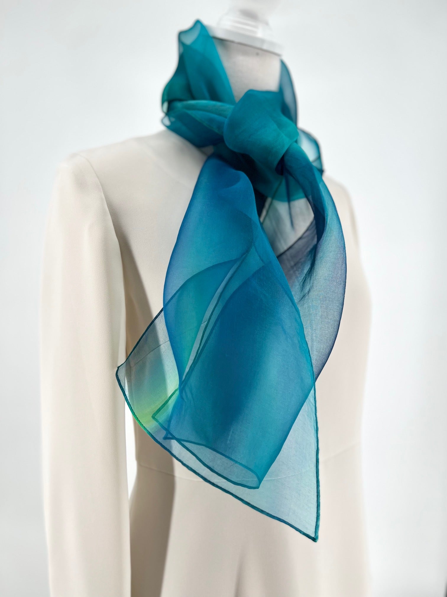 Experience the perfect harmony of art and elegance with our one-of-a-kind silk scarf—a designer accessory that transcends fashion into a realm of beauty and inspiration. Handcrafted with meticulous care, each piece is hand-dyed to create a stunning interplay of multicolor tones, forming a vibrant rainbow of hues that shimmer with soft transparency. Designed to complement any outfit, from casual wear to formal dresses, this versatile scarf enhances your personal style with a touch of uniqueness.